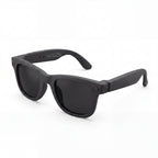 Clip camera glasses, matte black frame with dark lenses, three-quarter view